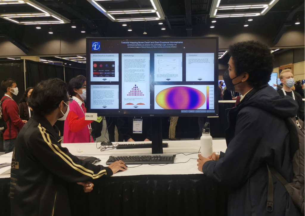 An image from the iPoster sessions at AAS241 Winter meeting. Front facing view of a large screen on a standing desk which is displaying an iPoster. 2 people stand wither side of the screen and they're both looking at the screen. 