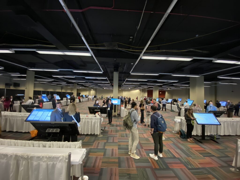 Wide shot of the crowd and display screens in the i-Presentation hall at the American Educational Research Association AERA 2023 Annual Meeting 